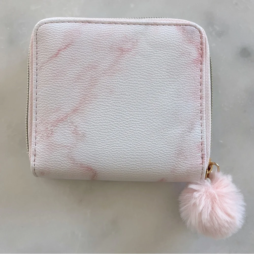 Claire’s pink tie dye wallet with pom pom zipper.